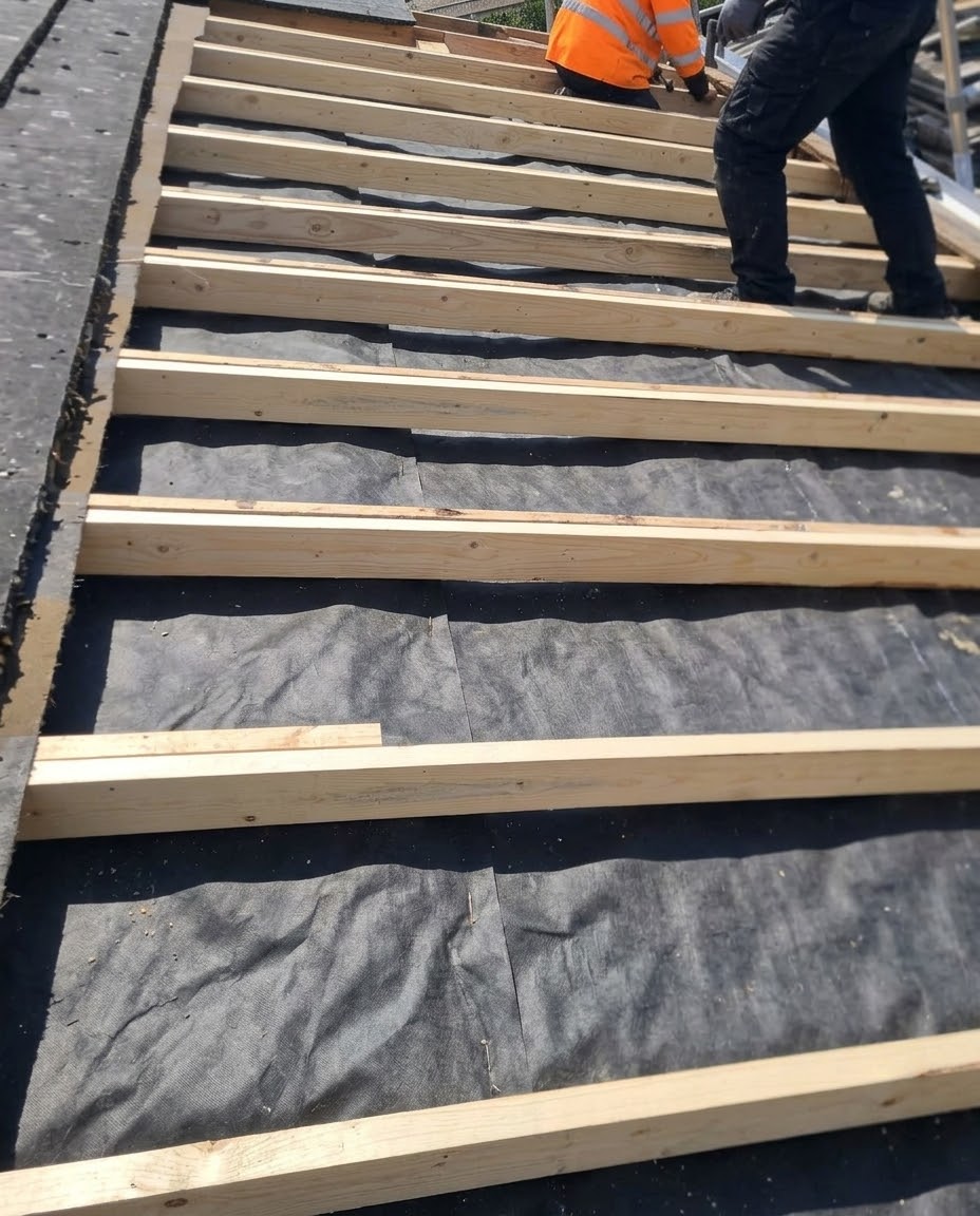 Roofers working on an old roof in Cork City