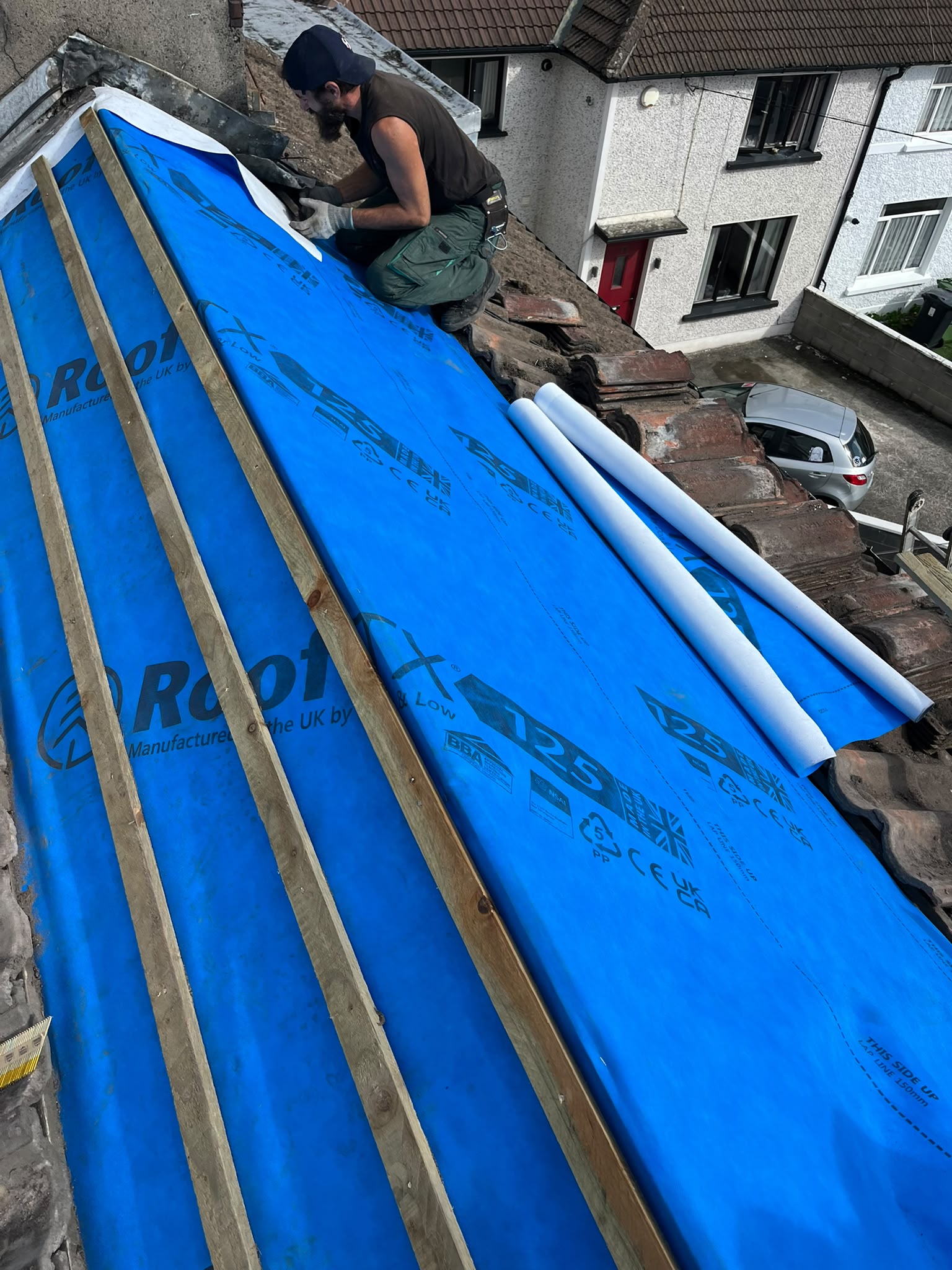 Roofers working on an old roof in Cork City